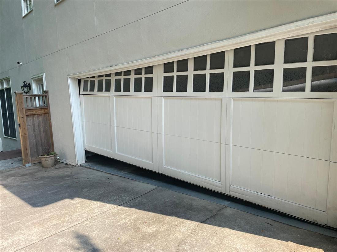 Garage door off its tracks before emergency repair